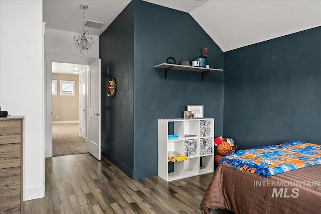 bedroom featuring lofted ceiling, baseboards, visible vents, and wood finished floors