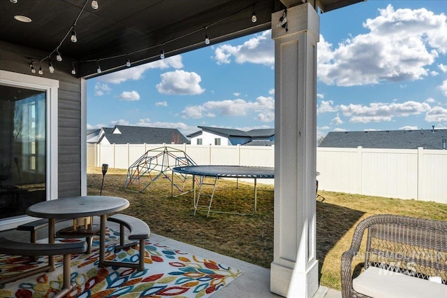 view of patio / terrace featuring a trampoline and a fenced backyard