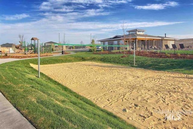 view of property's community featuring volleyball court and a lawn