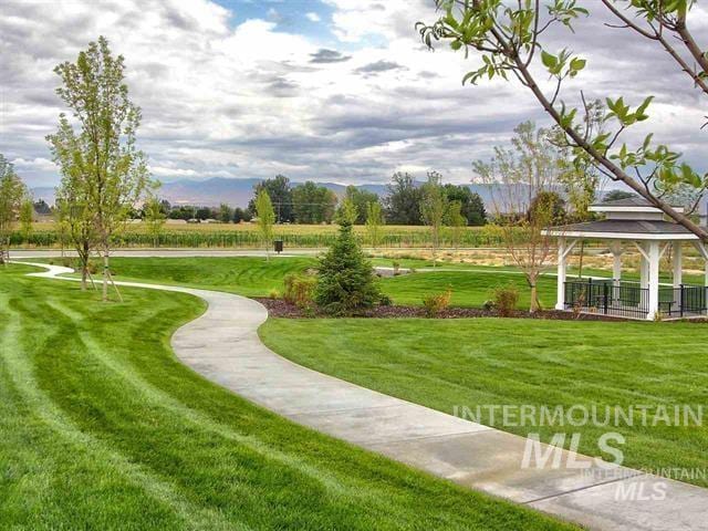 view of property's community with a lawn and a gazebo