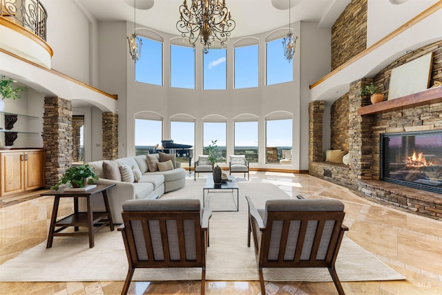 living room featuring a towering ceiling and a fireplace