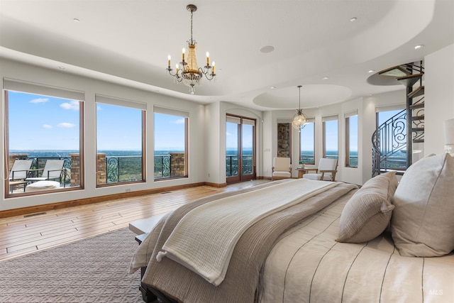 bedroom featuring wood-type flooring and a notable chandelier