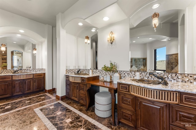 bathroom featuring vanity and backsplash