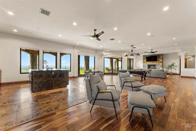 living room with hardwood / wood-style floors, a fireplace, and a wealth of natural light