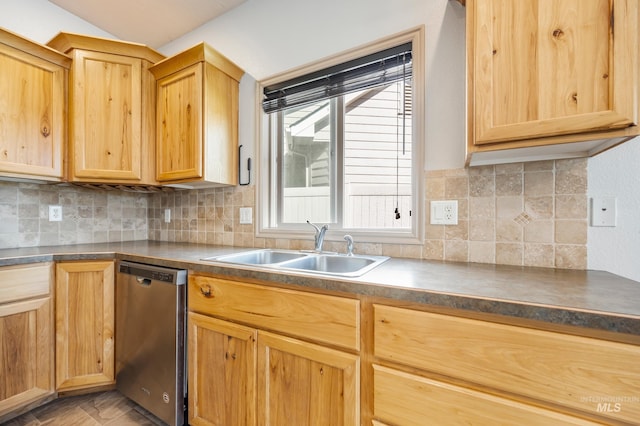 kitchen featuring dishwasher, dark countertops, light brown cabinets, and a sink