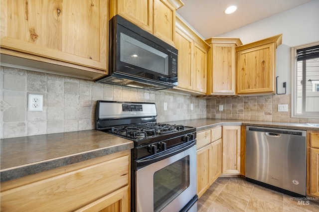 kitchen featuring dark countertops, light brown cabinets, tasteful backsplash, and stainless steel appliances