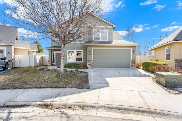 traditional-style home featuring driveway and fence