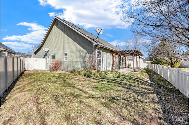 back of house with a gate, a lawn, a fenced backyard, and a pergola