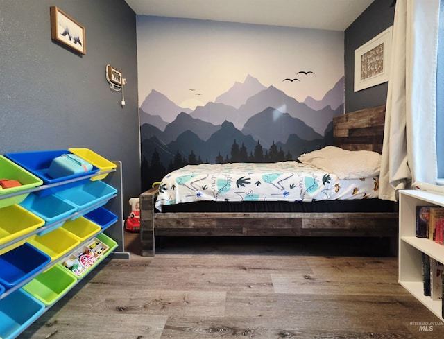 bedroom featuring wood finished floors