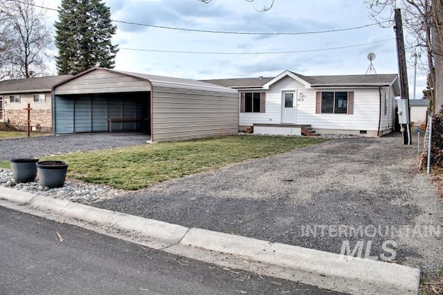 view of front of property with aphalt driveway, crawl space, and a carport