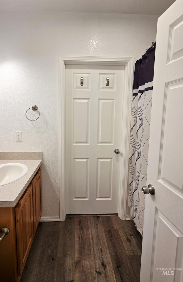 full bathroom with vanity and wood finished floors