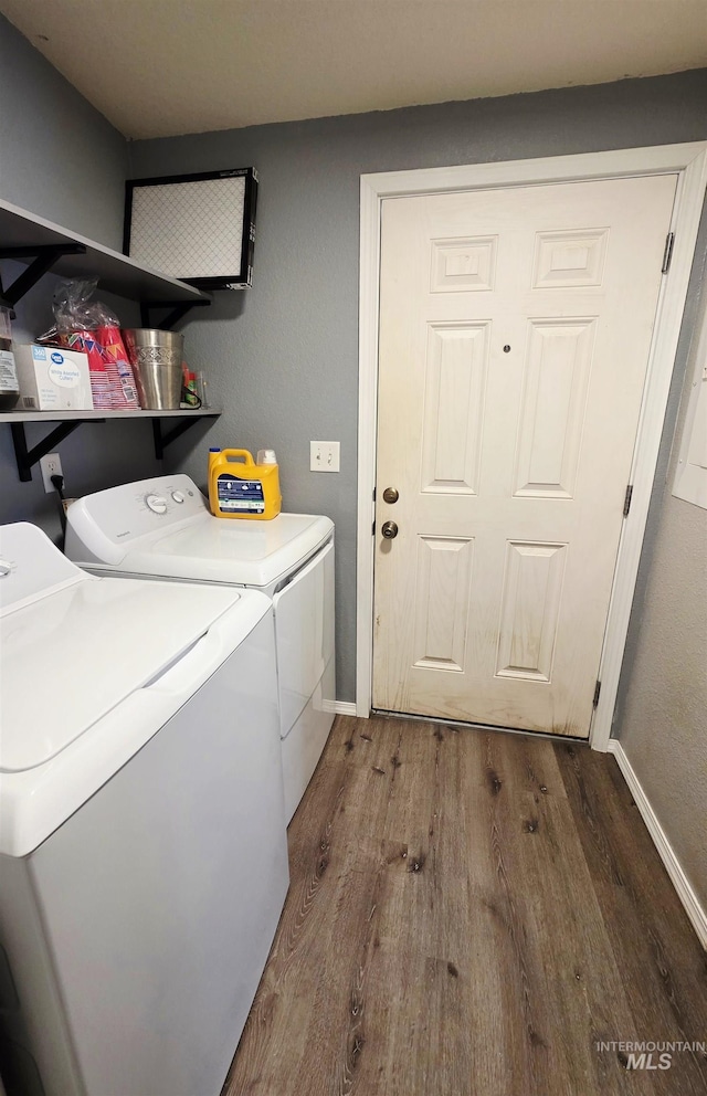 laundry room featuring laundry area, baseboards, washer and clothes dryer, and wood finished floors