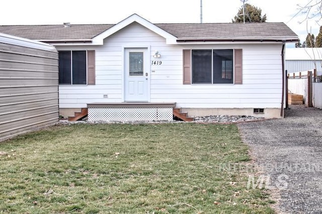 view of front of house featuring roof with shingles, crawl space, a front yard, and fence