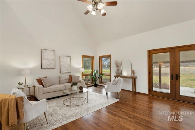 living room with ceiling fan, french doors, high vaulted ceiling, and wood-type flooring