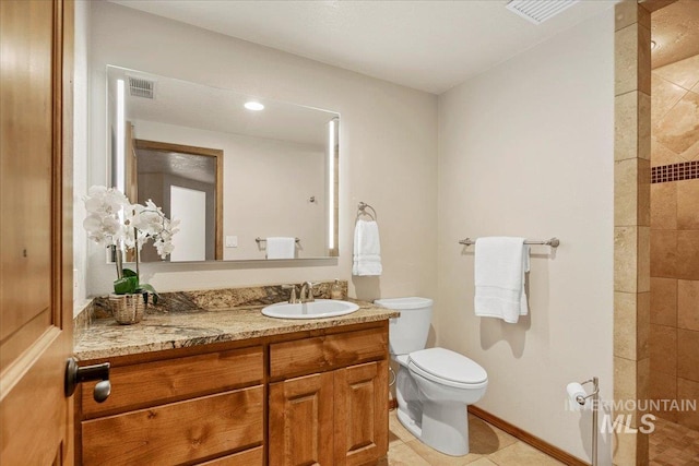 bathroom with tile patterned floors, walk in shower, vanity, and toilet