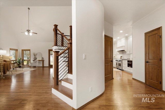 corridor featuring crown molding and hardwood / wood-style flooring