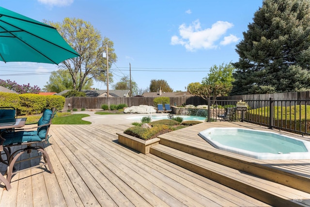 wooden deck featuring a fenced backyard and hot tub deck surround