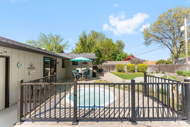 view of pool featuring a hot tub, outdoor dining area, a fenced backyard, and a patio area