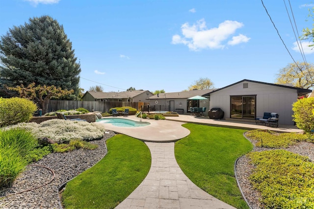 view of yard with a fenced in pool, a fenced backyard, a patio area, and a jacuzzi