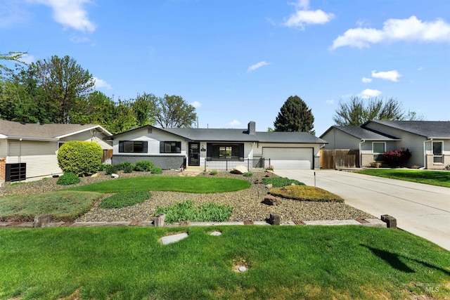ranch-style house with fence, an attached garage, a front yard, a chimney, and concrete driveway