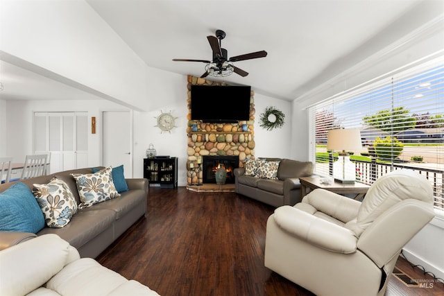 living area with a ceiling fan, vaulted ceiling, wood finished floors, and a fireplace