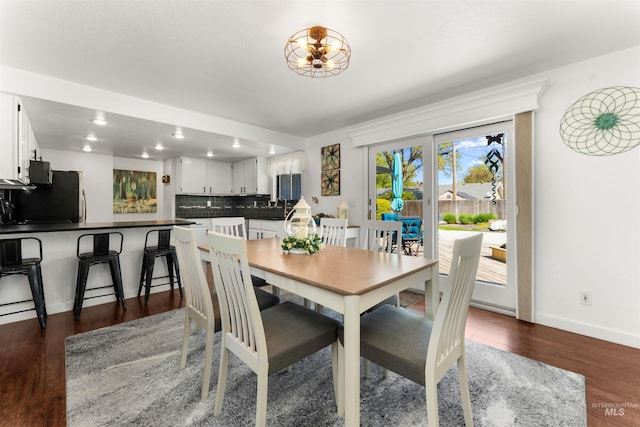 dining space with recessed lighting, dark wood-style flooring, and baseboards