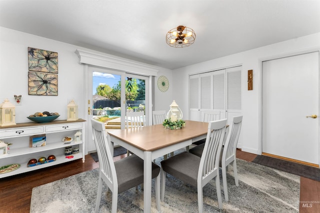 dining room with wood finished floors and a chandelier
