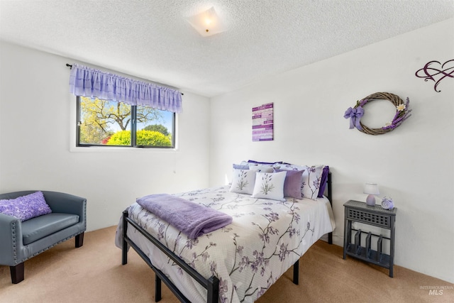 bedroom featuring carpet flooring and a textured ceiling
