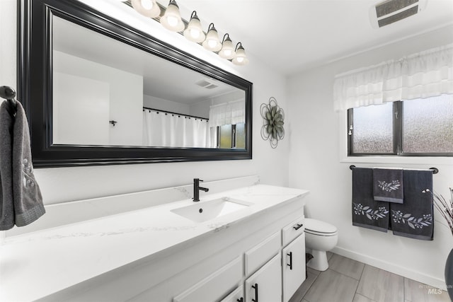 full bathroom with toilet, visible vents, and vanity