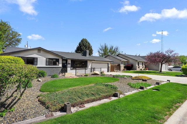 ranch-style house featuring a garage, fence, a front yard, a chimney, and driveway