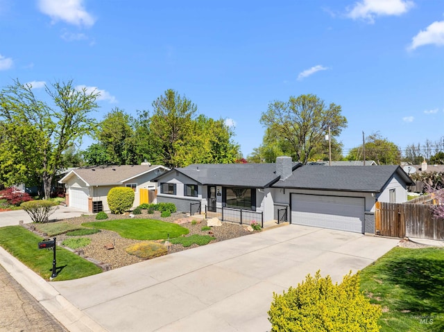 single story home featuring a garage, fence, driveway, and a front lawn