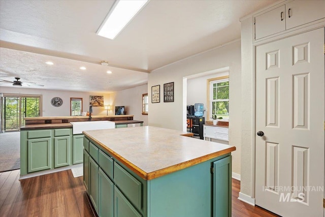 169W 200 N, Jerome, ID 83316 - kitchen with green cabinetry, a sink, a center island, recessed lighting, and dark wood-style floors