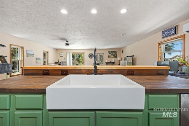 169W 200 N, Jerome, ID 83316 - kitchen featuring butcher block countertops, a textured ceiling, a sink, green cabinetry, and a ceiling fan