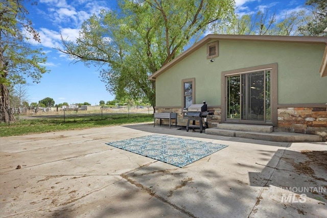 169W 200 N, Jerome, ID 83316 - back of property featuring a patio area, fence, stucco siding, and stone siding