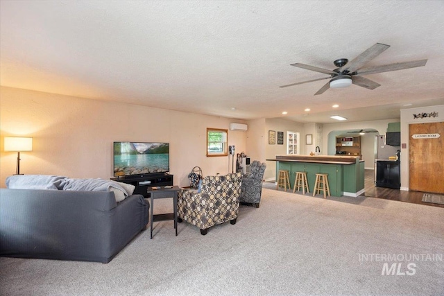 169W 200 N, Jerome, ID 83316 - carpeted living room with ceiling fan, a textured ceiling, arched walkways, recessed lighting, and an AC wall unit