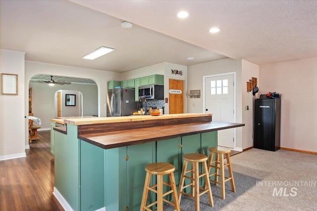 169W 200 N, Jerome, ID 83316 - kitchen featuring stainless steel appliances, arched walkways, wooden counters, baseboards, and recessed lighting