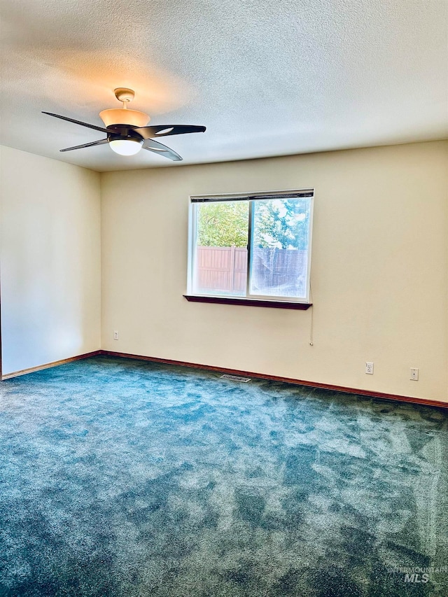 unfurnished room featuring carpet floors and a textured ceiling