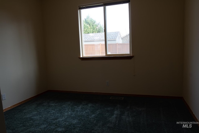 empty room featuring dark carpet