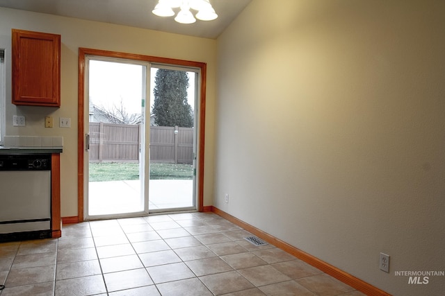 doorway to outside featuring a notable chandelier, light tile patterned floors, and lofted ceiling