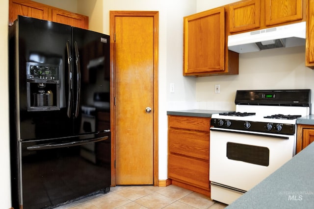 kitchen with light tile patterned flooring, black fridge with ice dispenser, and white range with gas stovetop