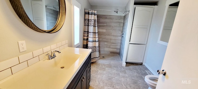 102 N Main St, Council, ID 83612 - full bathroom featuring vanity, a tile shower, toilet, and baseboards