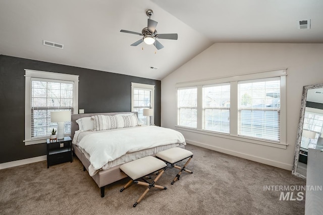 carpeted bedroom with multiple windows, vaulted ceiling, and ceiling fan