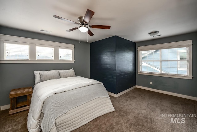 bedroom featuring ceiling fan and dark carpet