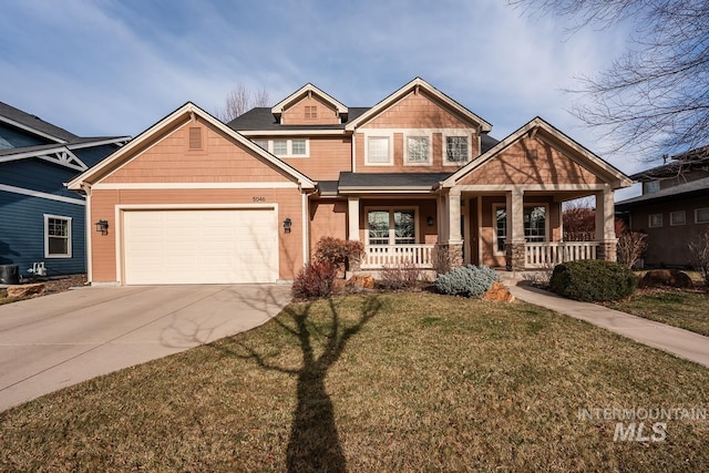 craftsman-style home with a porch, a garage, and a front yard