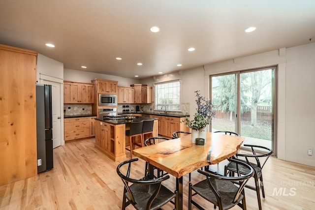 dining area featuring sink and light hardwood / wood-style flooring