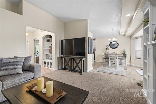 1902 E Birchwood Dr, Eagle, ID 83616 - living area featuring a chandelier, arched walkways, recessed lighting, and light carpet