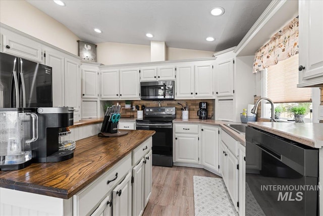 1902 E Birchwood Dr, Eagle, ID 83616 - kitchen with stainless steel microwave, black range with electric cooktop, wood counters, dishwashing machine, and white cabinetry