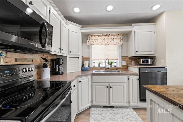 1902 E Birchwood Dr, Eagle, ID 83616 - kitchen featuring range with electric stovetop, dishwasher, white cabinets, backsplash, and light wood-type flooring