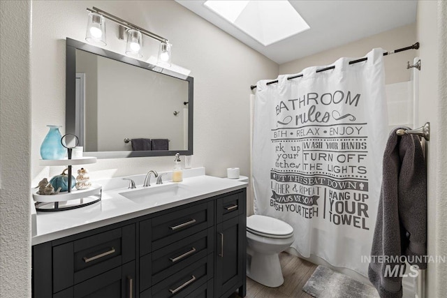 1902 E Birchwood Dr, Eagle, ID 83616 - full bathroom featuring a skylight, vanity, wood finished floors, and a shower with shower curtain