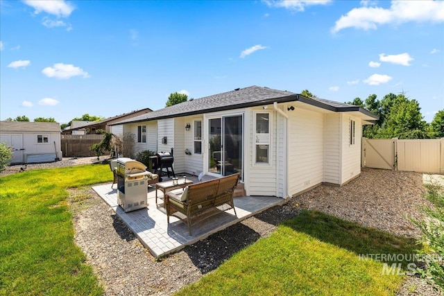 1902 E Birchwood Dr, Eagle, ID 83616 - back of house featuring a patio, a fenced backyard, a shed, and a gate